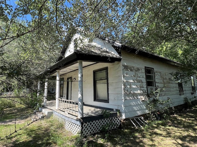 view of side of home with covered porch