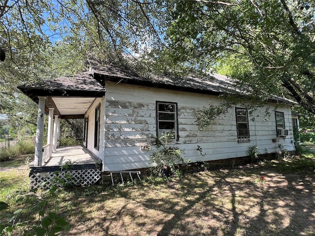 view of home's exterior featuring cooling unit and covered porch