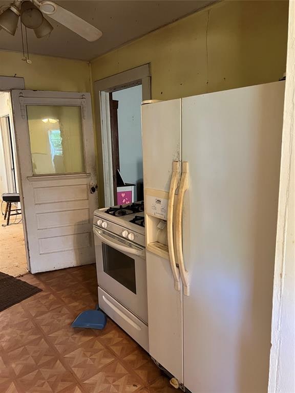 kitchen featuring parquet floors, white appliances, and ceiling fan