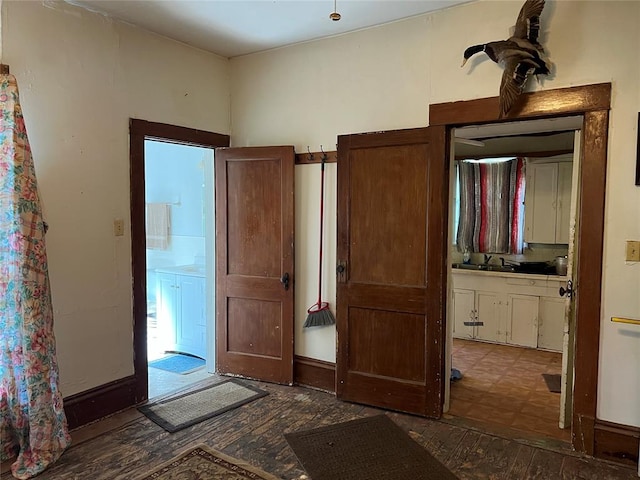 interior space featuring connected bathroom and dark wood-type flooring