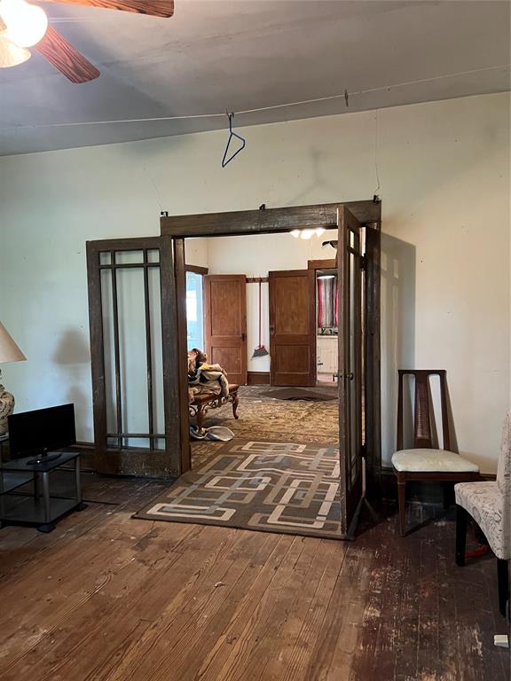 interior space featuring dark hardwood / wood-style flooring and ceiling fan