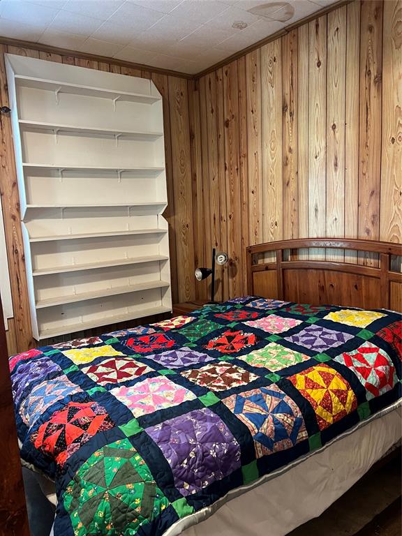 bedroom with wooden walls