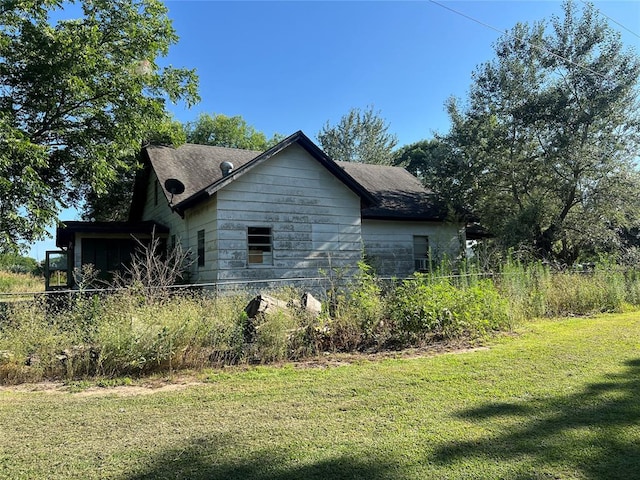 view of side of property with a yard