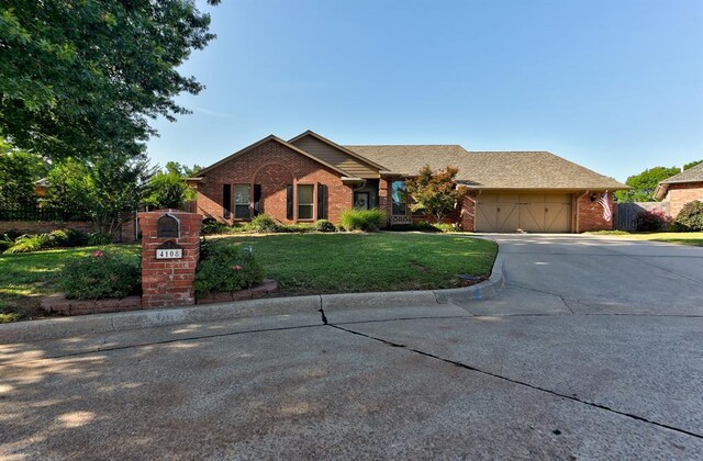 ranch-style house featuring a front lawn and a garage