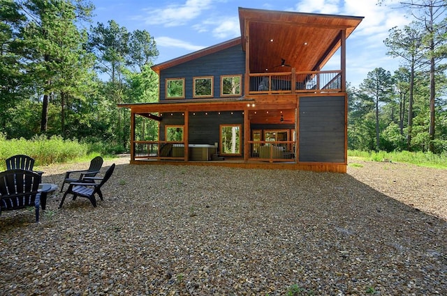 rear view of house featuring ceiling fan