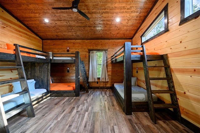 unfurnished bedroom with hardwood / wood-style floors, wooden ceiling, wooden walls, and vaulted ceiling