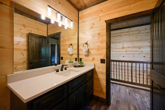 bathroom with vanity, hardwood / wood-style flooring, wooden ceiling, and wood walls