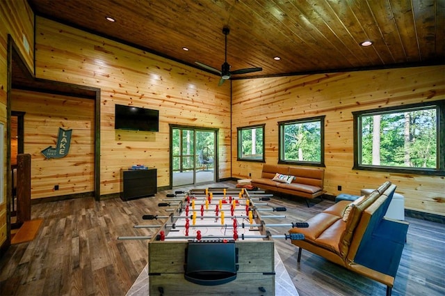 game room featuring ceiling fan, wooden ceiling, high vaulted ceiling, wood walls, and hardwood / wood-style flooring