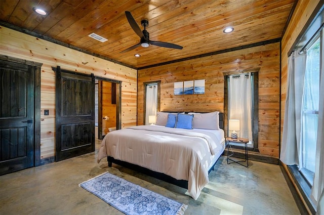 bedroom with ceiling fan, a barn door, wooden ceiling, and concrete flooring