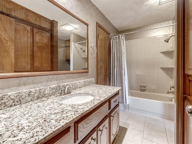 bathroom with tile patterned flooring, shower / bath combo, and vanity