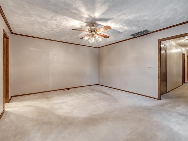 spare room featuring visible vents, crown molding, baseboards, and ceiling fan