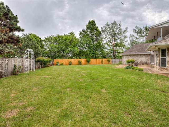 view of yard with a fenced backyard and a patio area