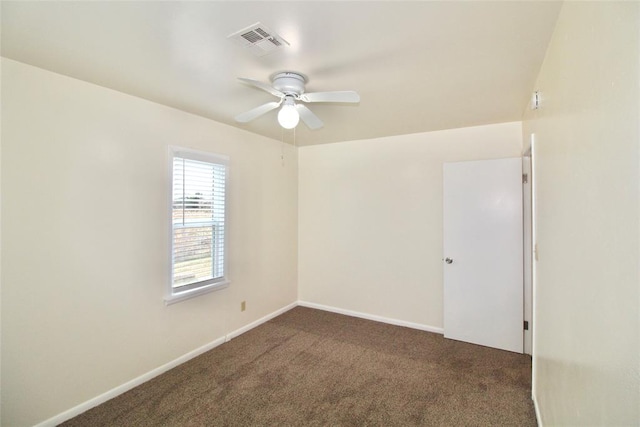 carpeted spare room featuring ceiling fan