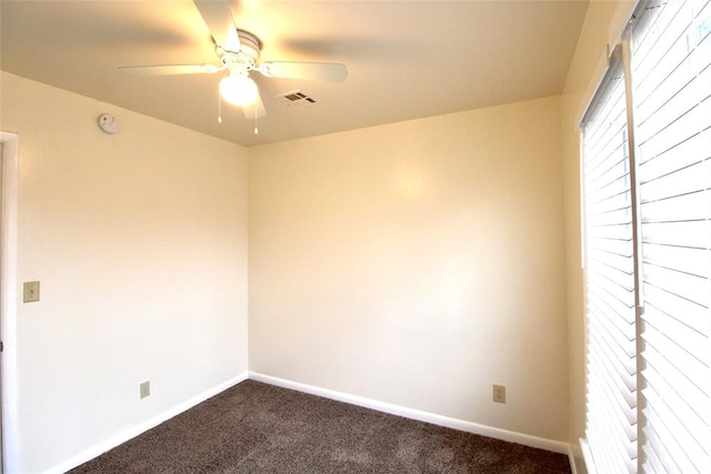 carpeted spare room with ceiling fan