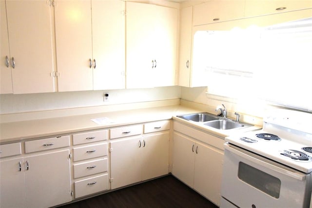 kitchen featuring electric range, dark hardwood / wood-style floors, white cabinetry, and sink