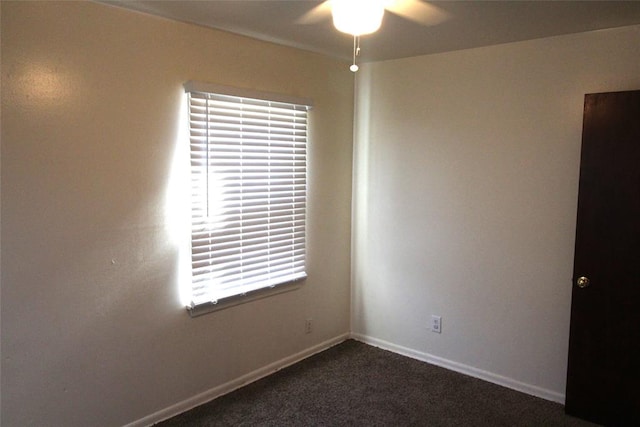 unfurnished room featuring dark colored carpet and ceiling fan