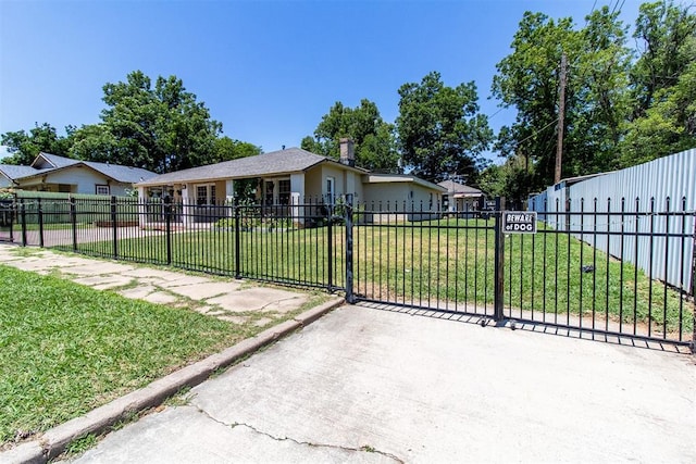 view of gate with a lawn