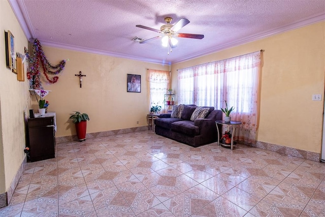 tiled living room with ceiling fan, a textured ceiling, and ornamental molding