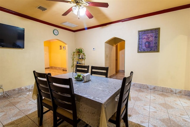 dining area with ceiling fan and ornamental molding