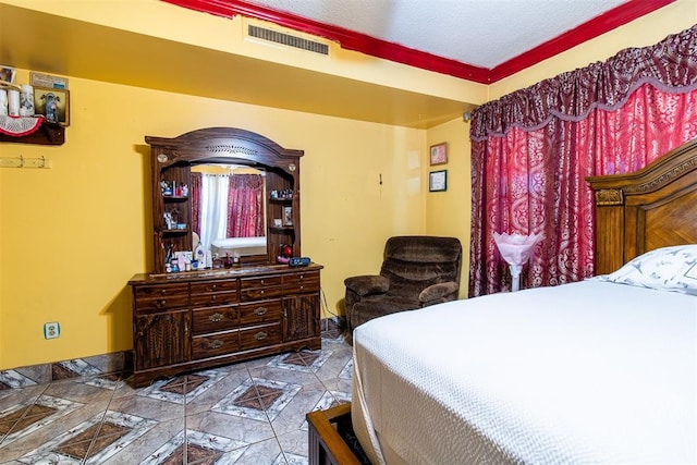 bedroom with crown molding and a textured ceiling