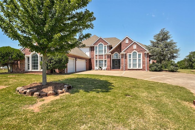 view of front of home with a garage and a front lawn