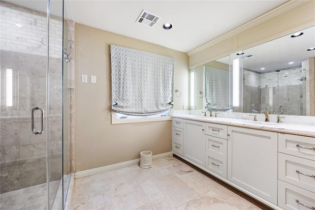 bathroom with vanity and a shower with shower door