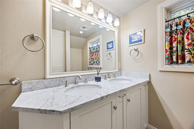 bathroom featuring vanity and vaulted ceiling