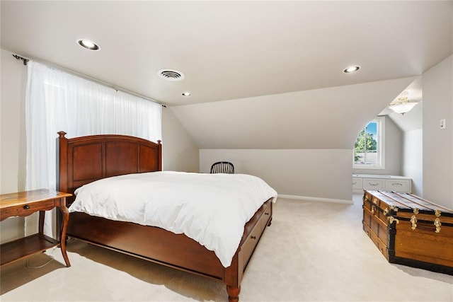 bedroom featuring light carpet and lofted ceiling