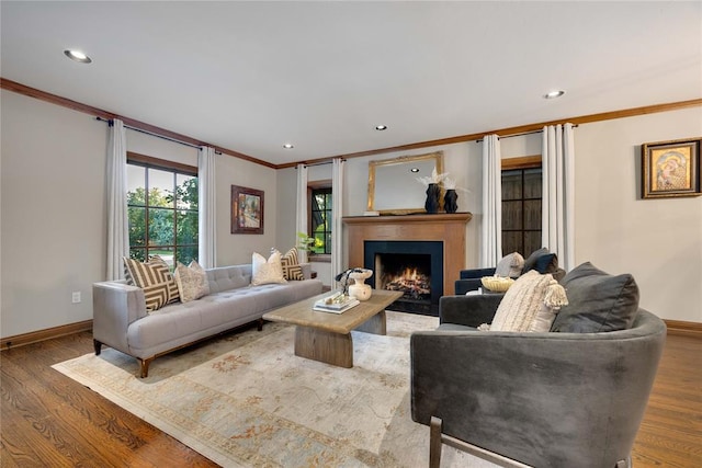 living room with hardwood / wood-style flooring and crown molding