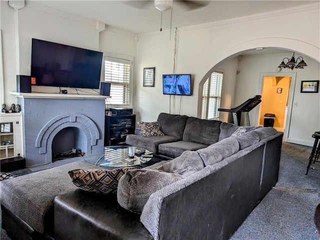315 W Filmore St, Mangum, OK 73554 - carpeted living room with a ceiling fan, arched walkways, ornamental molding, and a brick fireplace