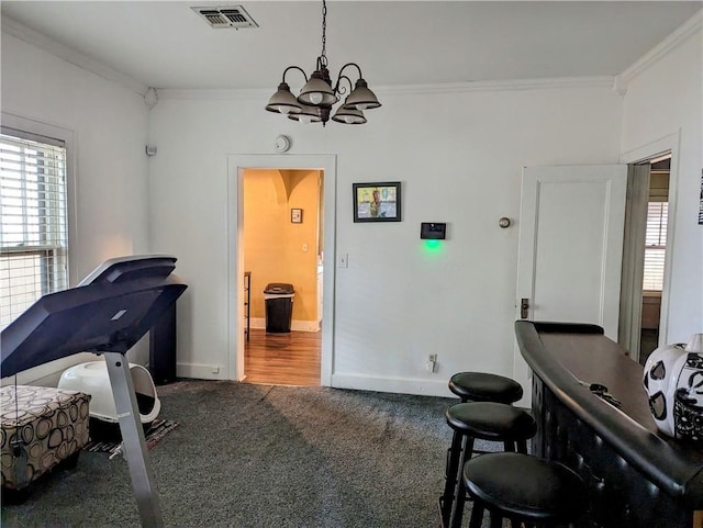 interior space with crown molding and a chandelier