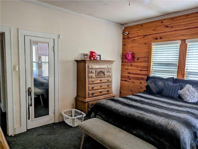 bedroom with carpet flooring, ornamental molding, and wooden walls