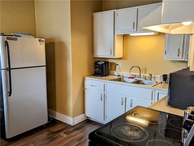 kitchen with stainless steel fridge, electric range oven, ventilation hood, sink, and white cabinets