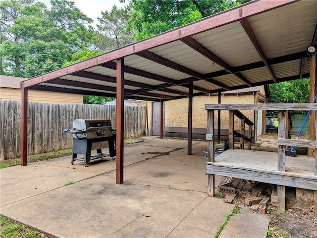 315 W Filmore St, Mangum, OK 73554 - view of patio / terrace featuring area for grilling, a detached carport, and a wooden deck