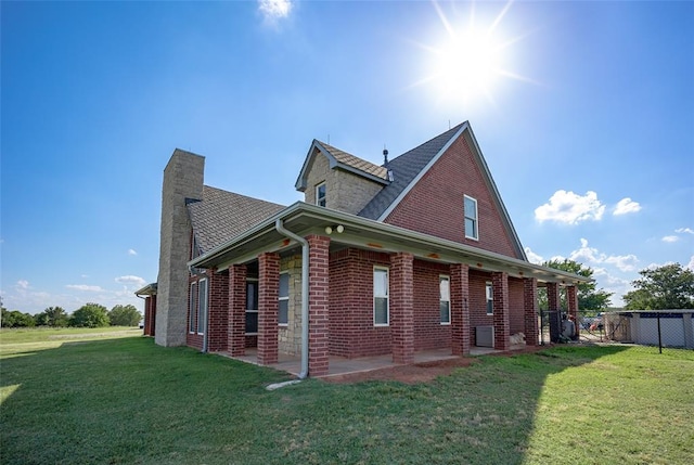 view of property exterior with a patio area and a lawn