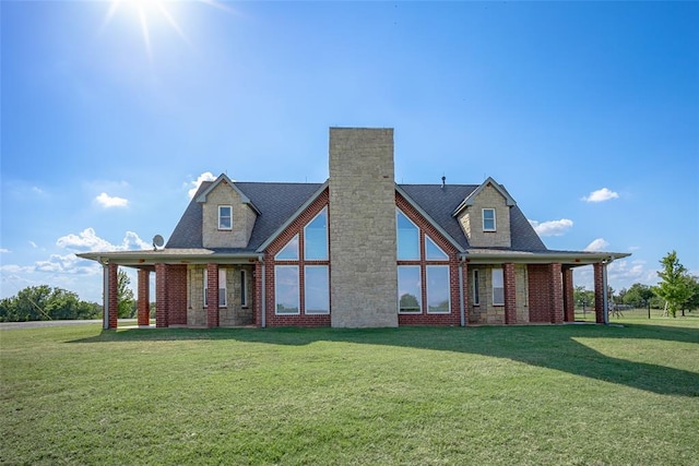 rear view of house featuring a yard