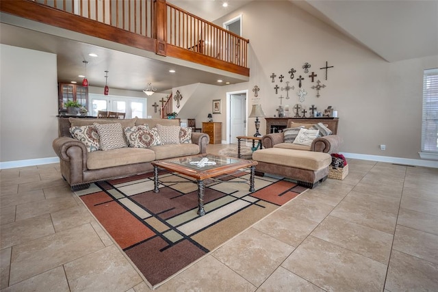 living room featuring high vaulted ceiling and a fireplace