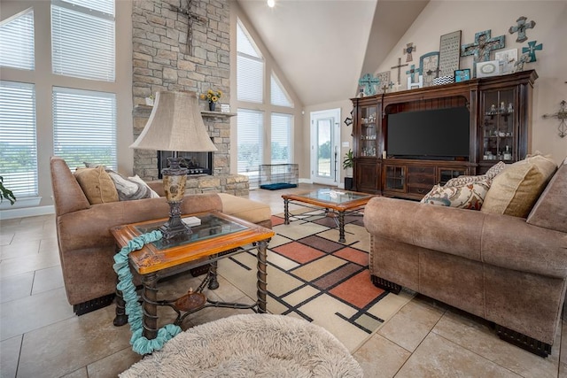 living room with high vaulted ceiling, plenty of natural light, and a stone fireplace