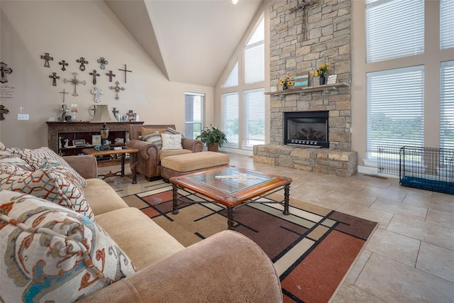 living room featuring a stone fireplace and high vaulted ceiling