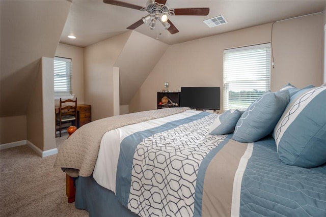 bedroom with ceiling fan, multiple windows, lofted ceiling, and carpet flooring