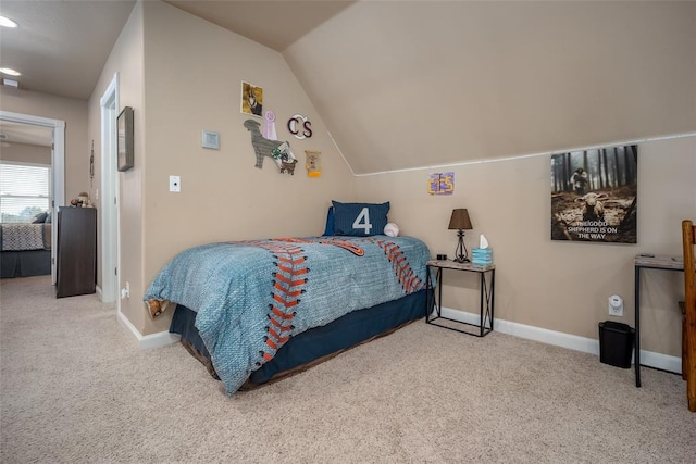 carpeted bedroom with vaulted ceiling