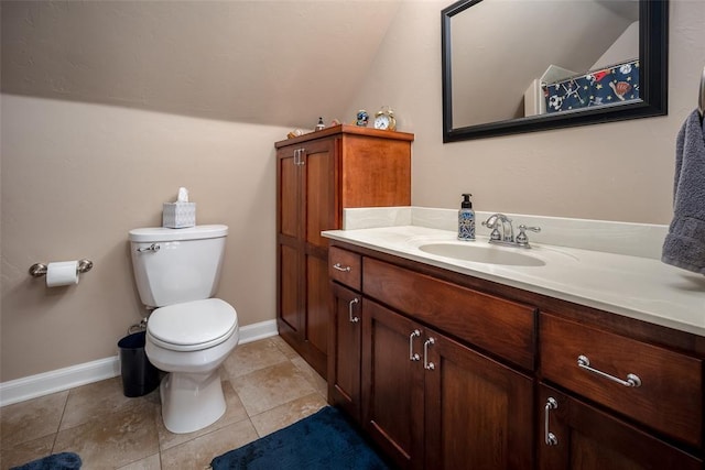 bathroom with toilet, vanity, and lofted ceiling