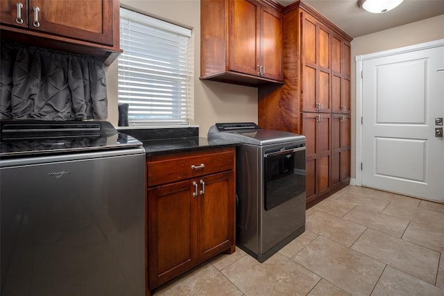 washroom featuring washing machine and dryer and cabinets