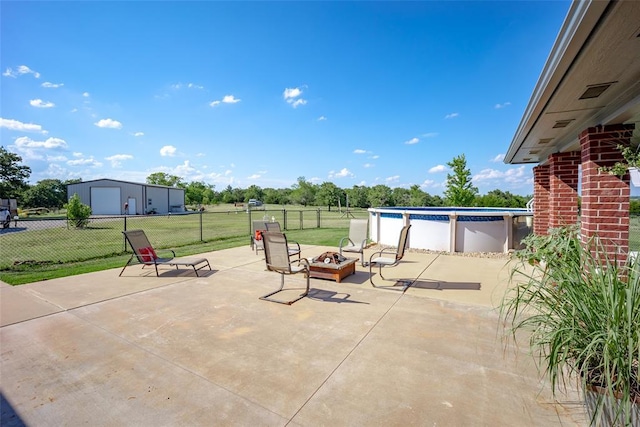 view of patio / terrace with a fenced in pool and an outdoor fire pit