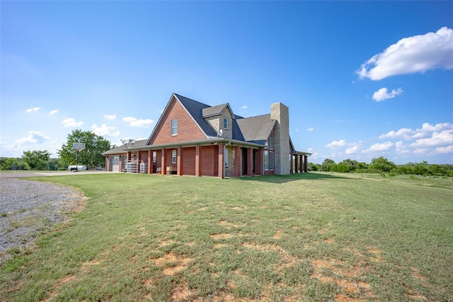 view of side of property with a yard and a garage