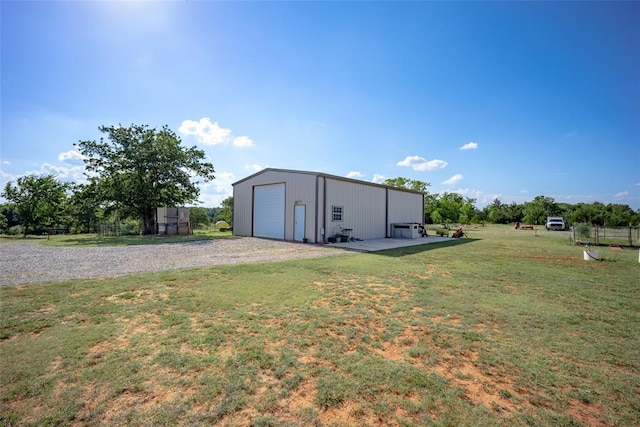 view of yard with a garage and an outdoor structure