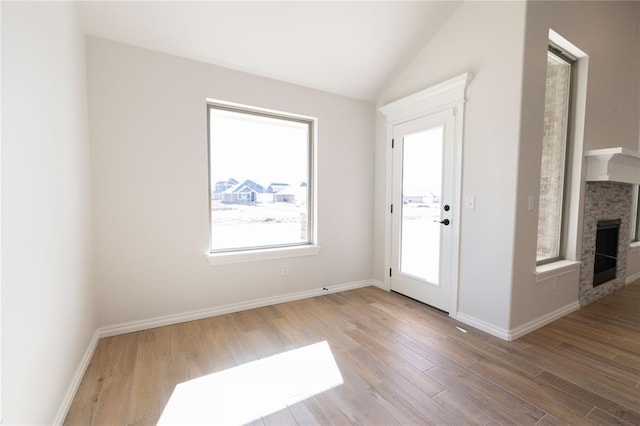 interior space featuring hardwood / wood-style floors, a healthy amount of sunlight, and vaulted ceiling