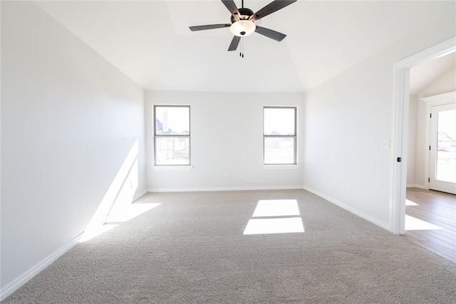 spare room featuring ceiling fan, light colored carpet, and lofted ceiling