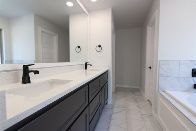 bathroom with vanity and a bath