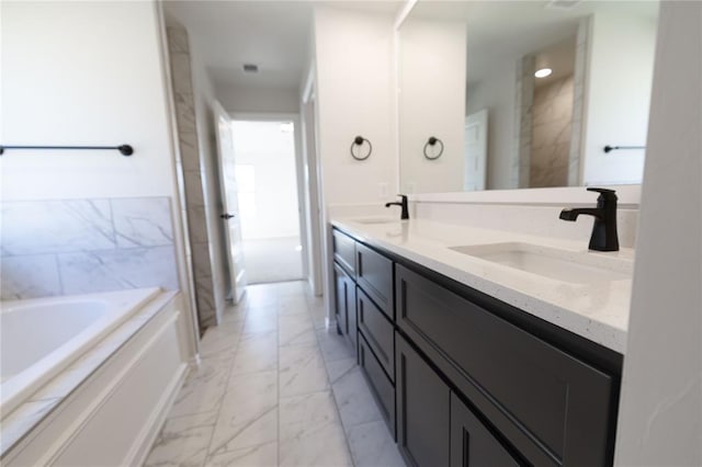 bathroom with vanity and a bathtub